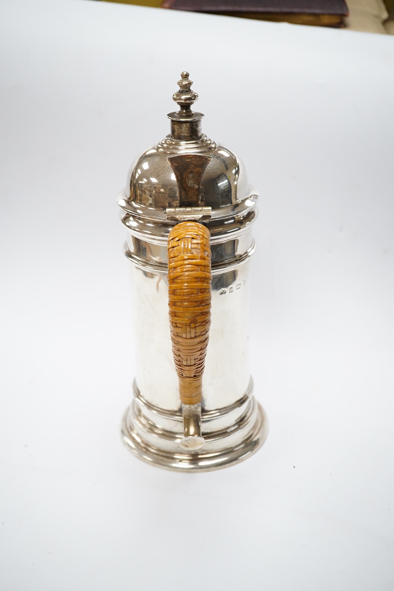 A George V silver cylindrical coffee pot, with a wicker handle, Birmingham, 1917 by Elkington & Co, 25.6cm, gross weight 23.1oz. Condition - fair